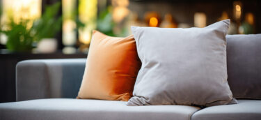 A cozy grey sofa with pillows for family relaxation.